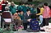 People Power Party floor leader Kweon Seong-dong, center, holds hands with a woman displaced by ongoing wildfires at a shelter in Andong, North Gyeongsang, on March 27. [NEWS1]