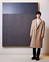 Actor Song Joong-ki stands next to one of late danseakhwa, or Korean monochrome painting, master Park Seo-bo's artwork, displayed at Louis Vuitton Maison Seoul in Gangnam Distrcit, southern Seoul. [LOUIS VUITTON]
