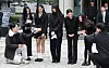 Members of girl group NewJeans answer questions from reporters outside the Seoul Central District Court in southern Seoul on March 7. [YONHAP]