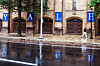 A woman walks by a Yale sign reflected in the rainwater on the Yale University campus in New Haven on Aug. 22, 2021. [AP/YONHAP]