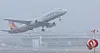 A plane takes off through a snowstorm at Jeju International Airport in Jeju on Feb. 7. [YONHAP]