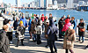 Foreign tourists look around Jagalchi Market in Busan on Dec. 4. [YONHAP]