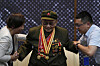 Yang Huafeng, a 92-year-old Chinese army veteran is helped as he meets reporters at the memorial of the September 18th History Museum in Shenyang, China on Aug. 12. [AP/YONHAP]