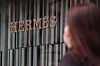 A passerby walks through an Hermès store in Seoul. [YONHAP]