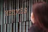 A passerby walks through an Hermès store in Seoul. [YONHAP]