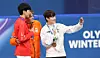 Rim Jong-un, right, who won the bronze medal in the men’s 1,000-meter short-track speed skating event, poses for a photo with gold medalist Jens van ’t Wout of the Netherlands and silver medalist Sun Long of China during the medal ceremony on Feb. 12 at the Milano Ice Skating Arena in Milan at the 2026 Milan-Cortina Winter Olympics. [KIM JONG-HO]