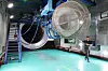 A Hanwha Aerospace employee explains about the company’s engine testing facility at Changwon, South Gyeongsang, during a press tour on April 24. [HANWHA AEROSPACE]