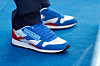 President Lee Jae-myung wears sneakers featuring his campaign's slogan during a rally in Hwaseong, Gyeonggi, on May 12. [JOINT PRESS CORPS]