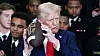 U.S. President Donald Trump holds a ball with his name on it, during a presentation of the Commander-in-Chief trophy to the the U.S. Navy Midshipmen football team of the United States Naval Academy, at the White House in Washington, D.C. on April 15. [REUTERS/YONHAP]