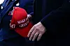 U.S. President Donald Trump holds a cap with his campaign slogan, 'Make America Great Again,' as he arrives at Philadelphia International Airport in Philadelphia on March 22. [REUTERS/YONHAP]