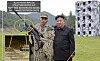 A photo released by the North’s state-run Korean Central News Agency (KCNA) shows that the model of the Blue House made by North Korea for training purposes (bottom left) has been deleted out from an official photo released by North Korean media in which the model was hidden from view. [SCREEN CAPTURE]