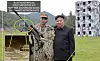 A photo released by the North’s state-run Korean Central News Agency (KCNA) shows that the model of the Blue House made by North Korea for training purposes (bottom left) has been deleted out from an official photo released by North Korean media in which the model was hidden from view. [SCREEN CAPTURE]