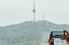 A guest takes a photo of N Seoul Tower from a Superior Room at Four Points by Sheraton Josun in Jung District, central Seoul. [FOUR POINTS BY SHERATON JOSUN, SEOUL MYEONGDONG]