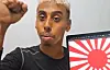 Johnny Somali, real name Ramsey Khalid Ismael, streams with the Japanese Rising Sun Flag displayed on his laptop on Oct. 30. [SCREEN CAPTURE]