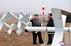 North's leader Kim Jong-un, right, inspects a performance test of drones on Thursday. [KOREAN CENTRAL NEWS AGENCY]