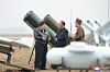 North's leader Kim Jong-un, right, inspects a performance test of drones on Thursday. [KOREAN CENTRAL NEWS AGENCY]