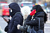 People clad in thick coats, mufflers and gloves walk on a street near Gwanghwamun Square in Jongno District, central Seoul on Dec. 26. [KANG JUNG-HYUN]