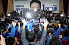 Officials and lawmakers from the liberal Democratic Party at the National Assembly in western Seoul raise their arms to cheer after exit poll results indicated its candidate Lee Jae-myung is likely to win in the presidential election on June 3. [KIM SEONG-RYONG]