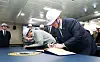 U.S. Secretary of the Navy John Phelan, right, signs a guest book aboard the ROKS Jeongjo the Great at HD Hyundai Heavy Industries' shipyard in Ulsan on April 30. [HD HYUNDAI]