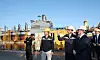 U.S. Secretary of the Navy John Phelan, fourth from left, and Hanwha Group Vice Chairman Dong Kwan Kim, third from left, tour the maintenance site of the USNS Yukon at Hanwha Ocean’s Geoje shipyard on April 30. [HANWHA OCEAN]