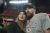 Kansas City Chiefs tight end Travis Kelce, right, is congratulated by Taylor Swift as they celebrate the Chiefs victory over the Buffalo Bills in the AFC Championship NFL football game, Jan. 26, in Kansas City. [AP/YONHAP]