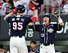 Heo Kyoung-min, right, of the Doosan Bears celebrates with Jared Young during a KBO game between the Bears and Kia Tigers at Kia-Gwangju Champions Field in Gwangju on Wednesday. [YONHAP]