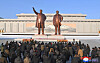 North Koreans visit the statues of late North Korean leaders Kim Il-sung, left, and Kim Jong-il on the occasion of the Lunar New Year in this image provided by the Korean Central News Agency on Jan. 30. [KOREAN CENTRAL NEWS AGENCY]