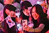 Olympic supporters take selfies with a lightstick made by HYBE and the Korean national flag Taegukgi on July 28, 2024, in Paris, France. [NEWS1]