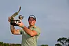 Viktor Hovland poses with the trophy after putting in to win on the 18th green during the final round of the Valspar Championship at Innisbrook Resort and Golf Club on March 23 in Palm Harbor, Florida. [GETTY IMAGES]