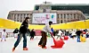 Tourists enjoy their time on an ice skating rink set up in front of the Seoul City Hall building in central Seoul on Dec. 20, 2025. [NEWS1]