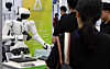 A humanoid robot plays dice games with visitors to the first AI EXPO in Magok in Gangseo District, western Seoul, on Wednesday. [YONHAP]