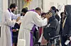 The Rev. Brian Strassburger, left, and the Rev. Flavio Bravo, right, bless migrants during Mass at the Casa del Migrant shelter in Reynosa, Mexico on Dec. 15, 2022. [AP/YONHAP]