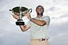 Scottie Scheffler of the United States poses for a photo with the FedExCup Trophy after winning the FedExCup and Tour Championship at East Lake Golf Club in Atlanta, Georgia on Sunday. [GETTY IMAGES]