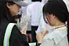 Citizens cool themselves with portable electric fans during an outdoor festival on May 22 in central Seoul. [YONHAP]