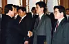 Kim Moon-soo, second from right, shakes hands with late President Kim Young-sam after being appointed head of Democratic Liberal Party’s Bucheon Sosa District chapter in Gyeonggi in an undated photo. [JOONGANG ILBO]