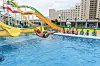 Tourists watch as a man uses a slide into a swimming pool at the Myongsasimni Water Park in the Wonsan Kalma Coastal Tourist Area in Wonsan, North Korea on July 2. [AFP/YONHAP]
