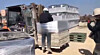 At a factory in Naju, South Jeolla, a case of human rights abuse unfolds as workers tie a migrant laborer to cargo. [JEONNAM MIGRANT LABOR HUMAN RIGHTS NETWORK]