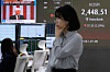 U.S. President Donald Trump is seen on a screen as a currency trader works at the foreign exchange dealing room of the Hana Bank headquarters in Seoul on April 3. [AP]