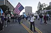 A woman holds an American flag upside-down during a protest on Tuesday, June 10, 2025, in Los Angeles. [AP/YONHAP]