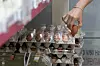 A customer picks out eggs at a supermarket in Seoul on June 22. [NEWS1]