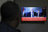 A man watches the news on TV, displaying footage of Ahmed al-Rahawi, the prime minister of the Houthi-controlled government, who was killed, along with others, in Thursday's Israeli strikes on the capital, in Sanaa, Yemen, Aug. 30. [AP/YONHAP]