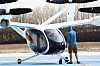 A technician gestures to a pilot flying an experimental Joby Dubai Aerial Taxi aircraft in Dubai, United Arab Emirates, on June 30, 2025. [REUTERS/YONHAP]