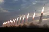 North Korean leader Kim Jong-un oversees the country's ″power demonstration firing″ of 600 mm super-large multiple rocket launchers the previous day, in a photo carried by its official Korean Central News Agency on Friday. [YONHAP]