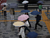 People walk with their umbrellas near the Seoul City Hall in Jung District, central Seoul, on Wednesday morning. [YONHAP]
