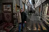 A man carries a carpet at Tehran's historic Grand Bazaar on Jan. 20, 2026, in Iran. [AP/YONHAP]