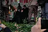 A woman mourns next to the flag-draped coffins of a group of security forces, who were killed during anti-government protests, during their funeral ceremony, in Tehran, Iran, on Jan. 14, 2026. [AP/YONHAP]