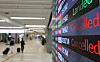An arrival board at Gimpo International Airport informs passengers of delays and cancellations in flight schedules on Sunday as monsoon rain and strong winds disrupted flight operations in the country’s southern regions such as Busan and Jeju Island. [YONHAP]