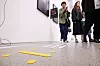Braille blocks on a museum floor with visitors walking nearby at the National Museum of Modern and Contemporary Art, Korea in Seoul.