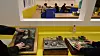 People examine tactile art pieces displayed on a yellow table at F1963 in Busan.