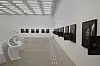 Gallery interior at MMCA Seoul with Braille blocks leading past wall-mounted artworks.